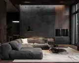Nuancier : le gris foncé du canapé se marie aux tons chauds du bois et à la texture brute du mur.