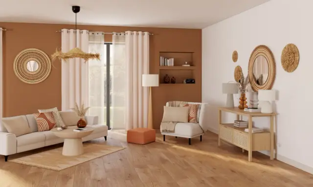 Un salon **cocooning salon bois et blanc** avec canapé, fauteuil, table basse et console. Décoration murale en rotin et coussins aux motifs géométriques.